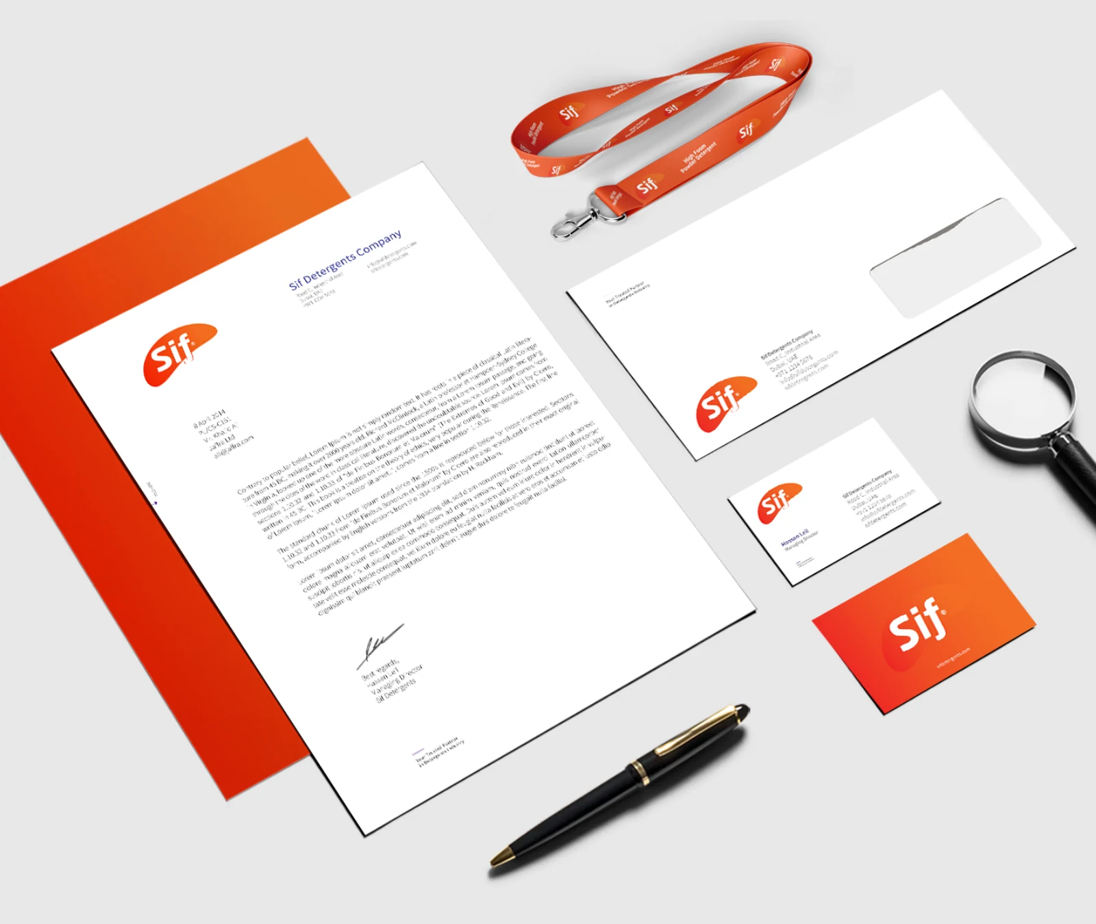 Stationery system across letterhead, envelopes, business cards and a lanyard.